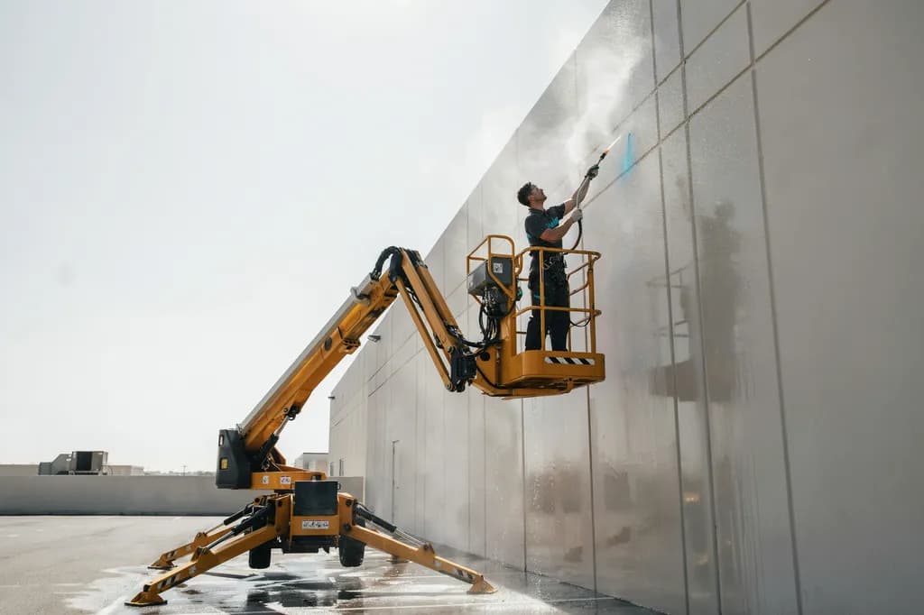 A commercial building exterior being soft-washed clean