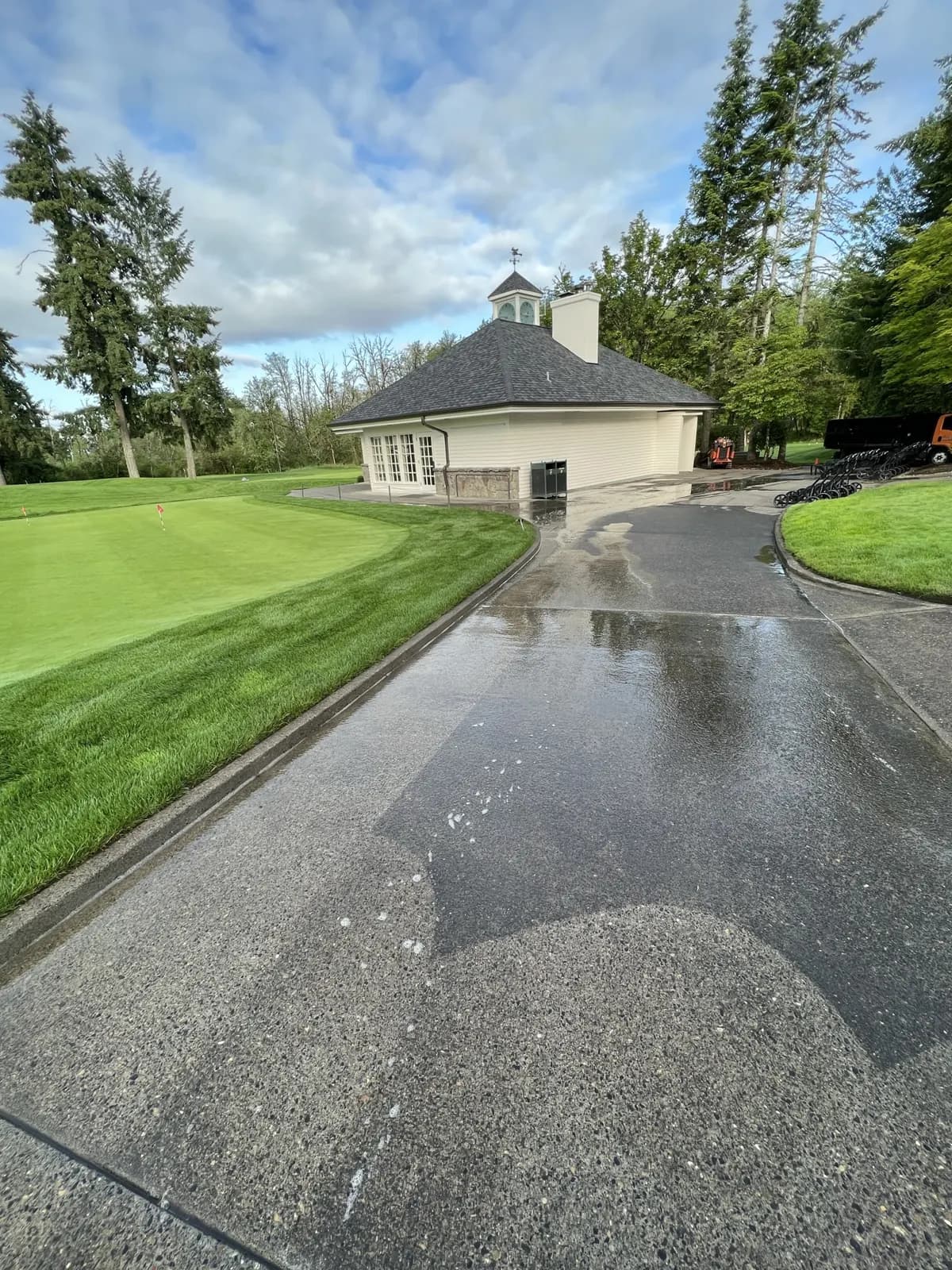 Curving driveway past a pro shop with the cleaned section still wet